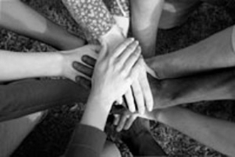 Hands crossed in unity (group huddle)